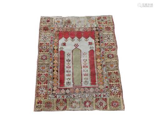 A Turkish prayer rug, the ivory mihrab within a yellow border with large flowerheads and guls, 146 x