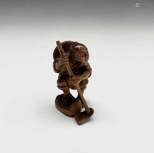 A Japanese carved wood netsuke, signed, 20th century, height 5.5cm.