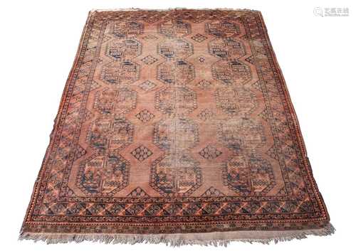 An Afghan Ersari carpet, the camel field with six rows of three octagonal medallions, within a