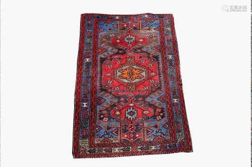 A Hamadan rug, North West Persia, the indigo field with a large polychrome lobed medallion within an