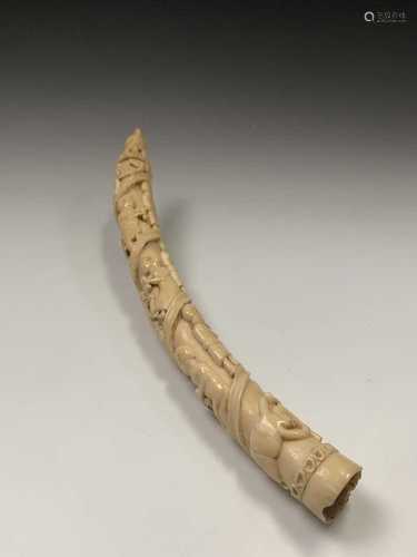 An African Loango ivory tusk, late 19th century, carved with porters some of which are carrying