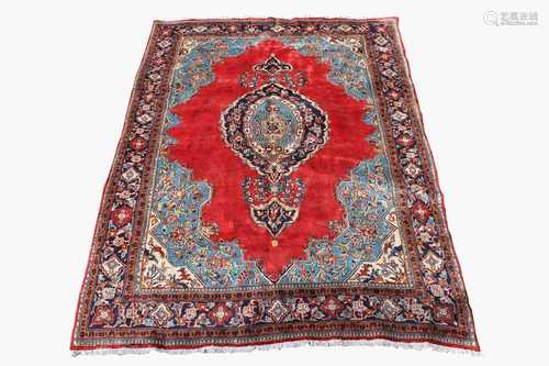 A Mahal carpet, West Persia, the madder field with a central polychrome lobed medallion, within an