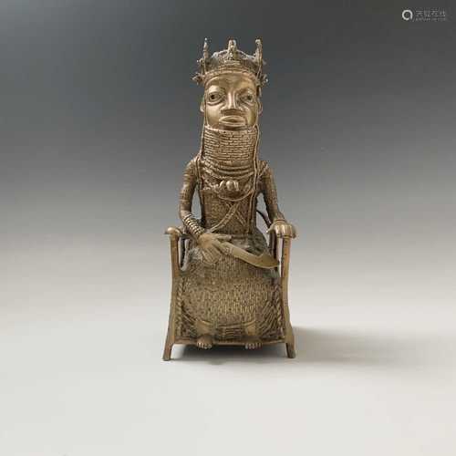 A Bennin bronze model of a seated chief, height 28.5cm, width 11cm.