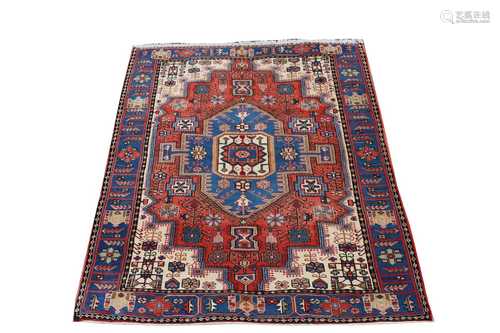 A Hamadan rug, North West Persian, the madder field with a central polychrome medallion, ivory