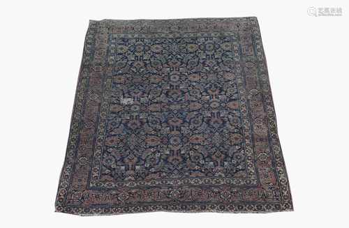 A Khorassan rug, North East Persia, the indigo field with all over herati design, within a madder