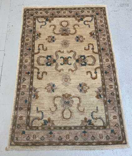 A Ziegler Chobi rug, the ivory field with palmettes and flowering vines, within a meandering