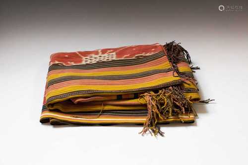 A warp Ikat cotton weaving, Sumatra, Indonesia, decorated with a figure holding an umbrella and a