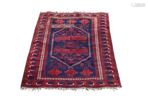 A Belouch rug, the indigo field with a large hexagonal stepped medallion, with guls and stylised