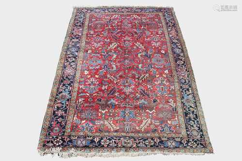 A Heriz carpet, North West Persia, the madder field with an all over design of palmettes , flowering