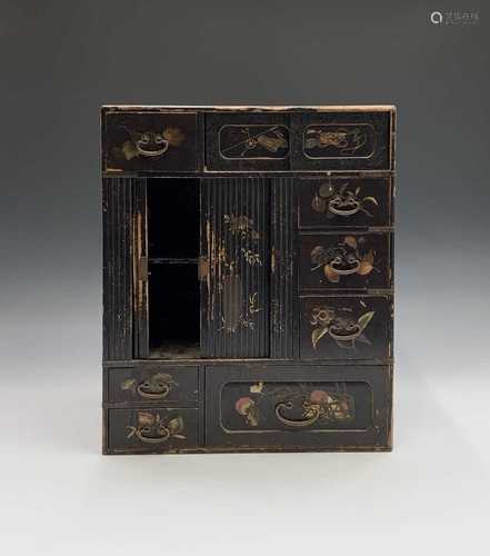 A Japanese black lacquered table cabinet, 19th century, with a pair of sliding doors, seven