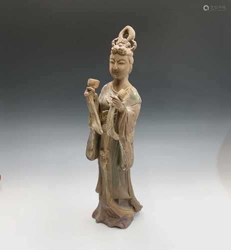 A Chinese earthenware figure of Guanyin, with a goblet in each hand, height 53cm.