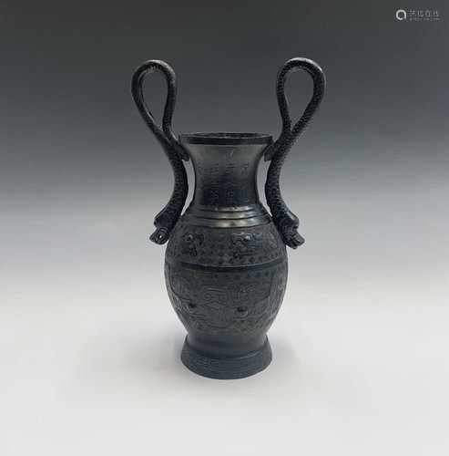 A Chinese bronze archaic style vase, circa 1900, with serpent handles flanking rows of