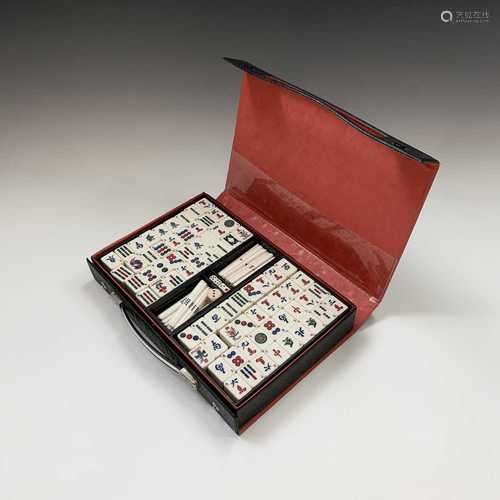 A Mahjong set, in black leather case, with 'Mah jong Handbook For Beginners, by 'Futami Kogeisha,