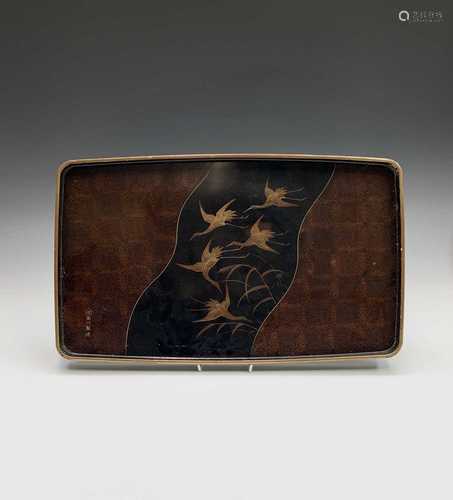 A Japanese lacquered tray, 19th century, signed, the centre with a shaped black panel with cranes in