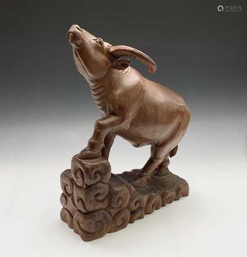 A large carved wood model of a water buffalo, circa 1920's, height 53cm, width 38cm, depth 14cm.