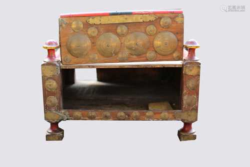 An Indian low table, the lift up front with circular brass mounts, surmounted by four turned