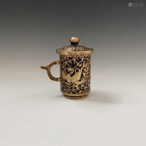 A Tang style hardstone gilded tankard and cover, with stylised birds amongst leavy tendrils,