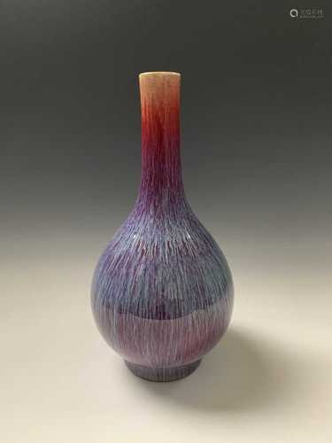 A Chinese flambe glazed bottle vase, 18th century, of crimson, blue, purple and lavender tone,