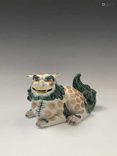 A Japanese porcelain shishi or lion dog, late 19th century, height 12cm, width 20cm.