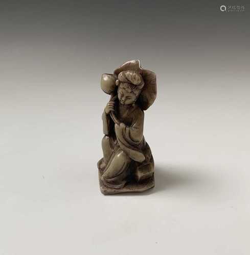 A Chinese soapstone figure, of a seated female, on a wooden stand, total height 11cm.