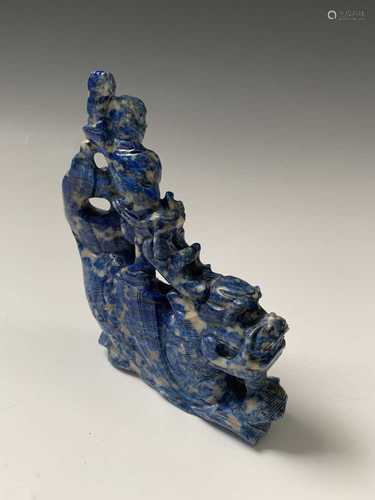 A Chinese lapis lazuli carving of a boy on a sea serpent, height 11cm, width 10cm.