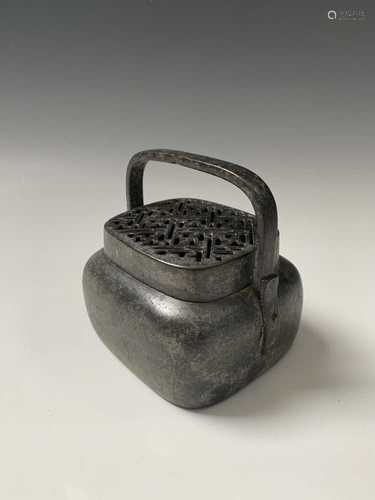 A Chinese bronze hand warmer, 18th/19th century, with swing handle and pierced cover, height 7cm,