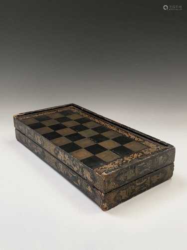 A Chinese export black lacquered folding games board, 19th century, for chess and backgammon,