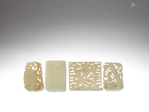 A group of four various white and pale green jade pendants Qing Dynasty