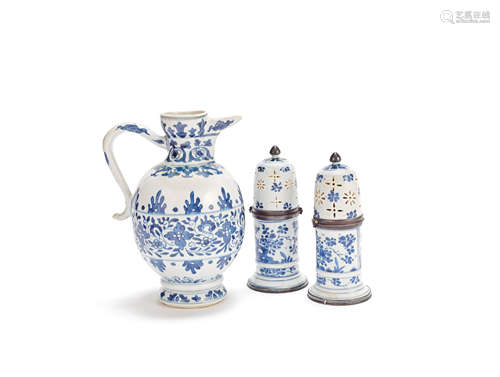 A blue and white 'floral' jug and a pair of white metal-mounted blue and white sugar casters The porcelain Kangxi