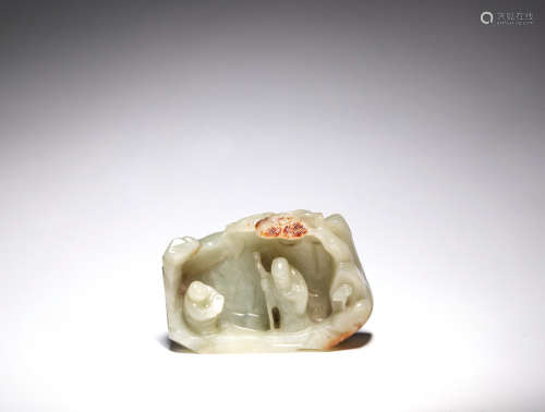 A pale green and russet jade grotto group Qing Dynasty