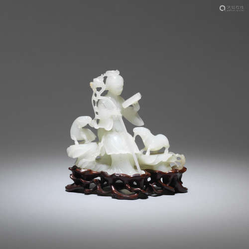 A white jade figure of a lady and two rams