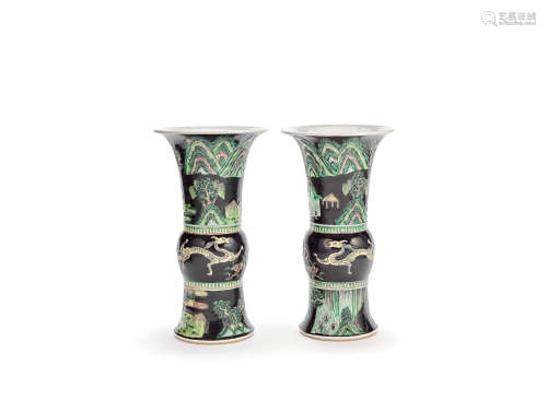 An associated mirrored pair of moulded black-ground famille verte beaker vases, gu Chenghua six-character marks, late Qing Dynasty