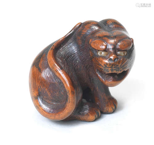 A wood netsuke of a seated tiger By Hakuryu II, 19th century