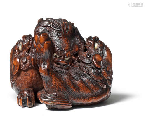 A wood netsuke of three shishi By Sato Masayoshi, mid-19th century