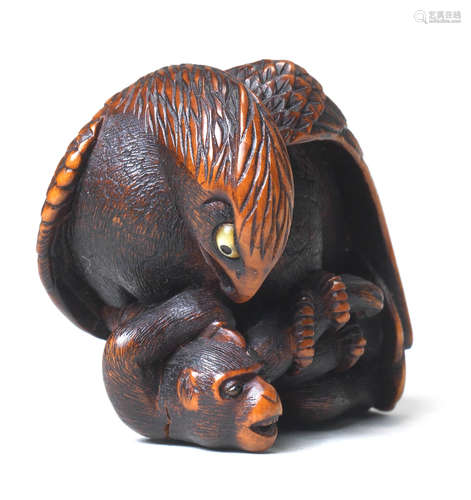 A wood netsuke of an eagle and monkey By Masatsugu, 19th century