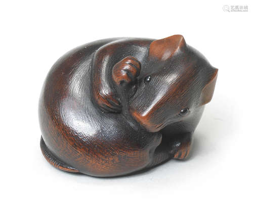 A wood netsuke of a rat with its head turned back By Ikkan (1817-1893), Nagoya, mid-19th century