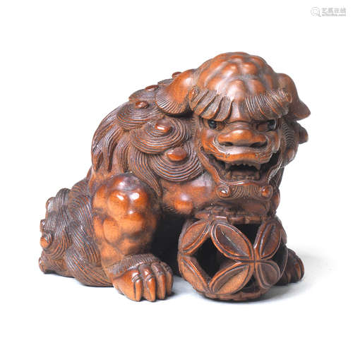 A wood netsuke of a shishi By Suketada, Takayama, Hida Province, late 19th century