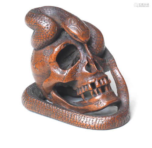 A boxwood netsuke of a snake and skull By Kawakata Masanori, late 19th century