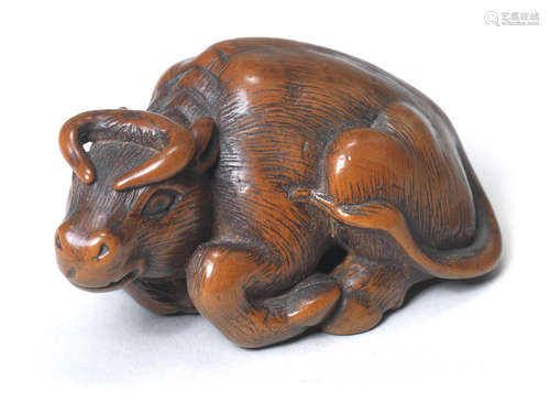 A wood netsuke of a recumbent ox By Kokei, Kuwana, Ise Province, late 18th century