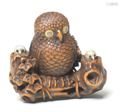 A wood netsuke of an owl and young on a branch By Masatsugu, 19th century