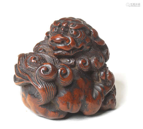 A small wood netsuke of a shishi By Tametaka, Nagoya, 18th century