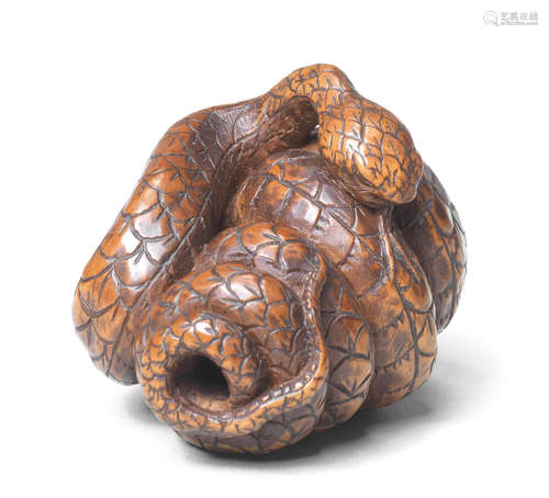 A wood netsuke of a snake By Tametaka, Nagoya, 18th century