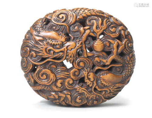 A boxwood manju netsuke of two dragons 19th century