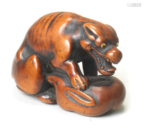 A wood netsuke of a wolf After Okatomo, Kyoto, early 19th century