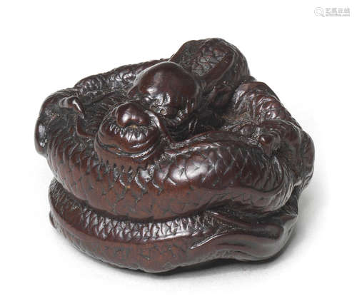 A wood netsuke of a dragon By Tametaka, Nagoya, 18th century