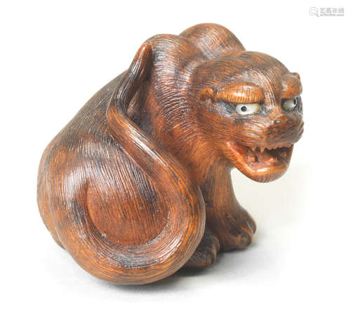 A wood netsuke of a seated tiger By Hakuryu II, Kyoto, 19th century