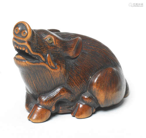 A boxwood netsuke of a boar By Nanboku, mid-19th century