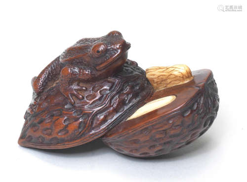 A wood netsuke of a frog on a split walnut By Matsuda Sukenaga, Takayama, Hida Province, mid-19th century