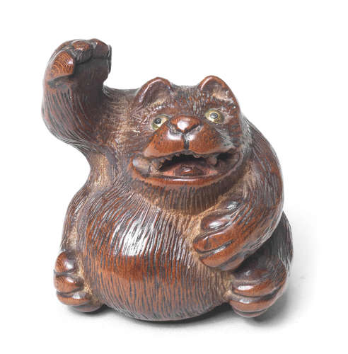 A wood netsuke of a tanuki By Tanaka Minko (1735-1816), Tsu, late 18th century