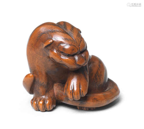 A boxwood netsuke of a tiger By Masataka, early 19th century